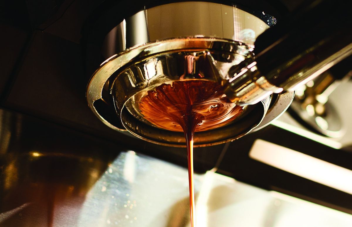 Espresso pouring from a portafilter at a Torino caffè bar